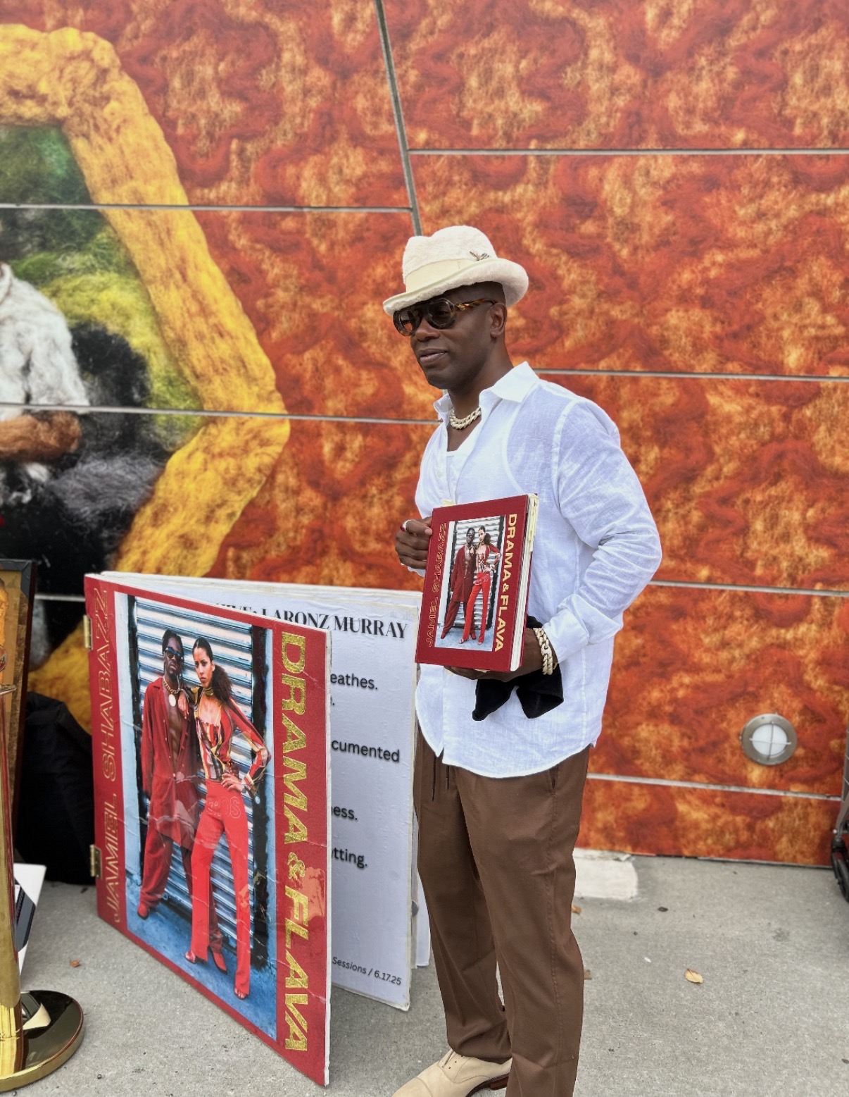 LaRonz Murray in front of the Drama & Flava book
